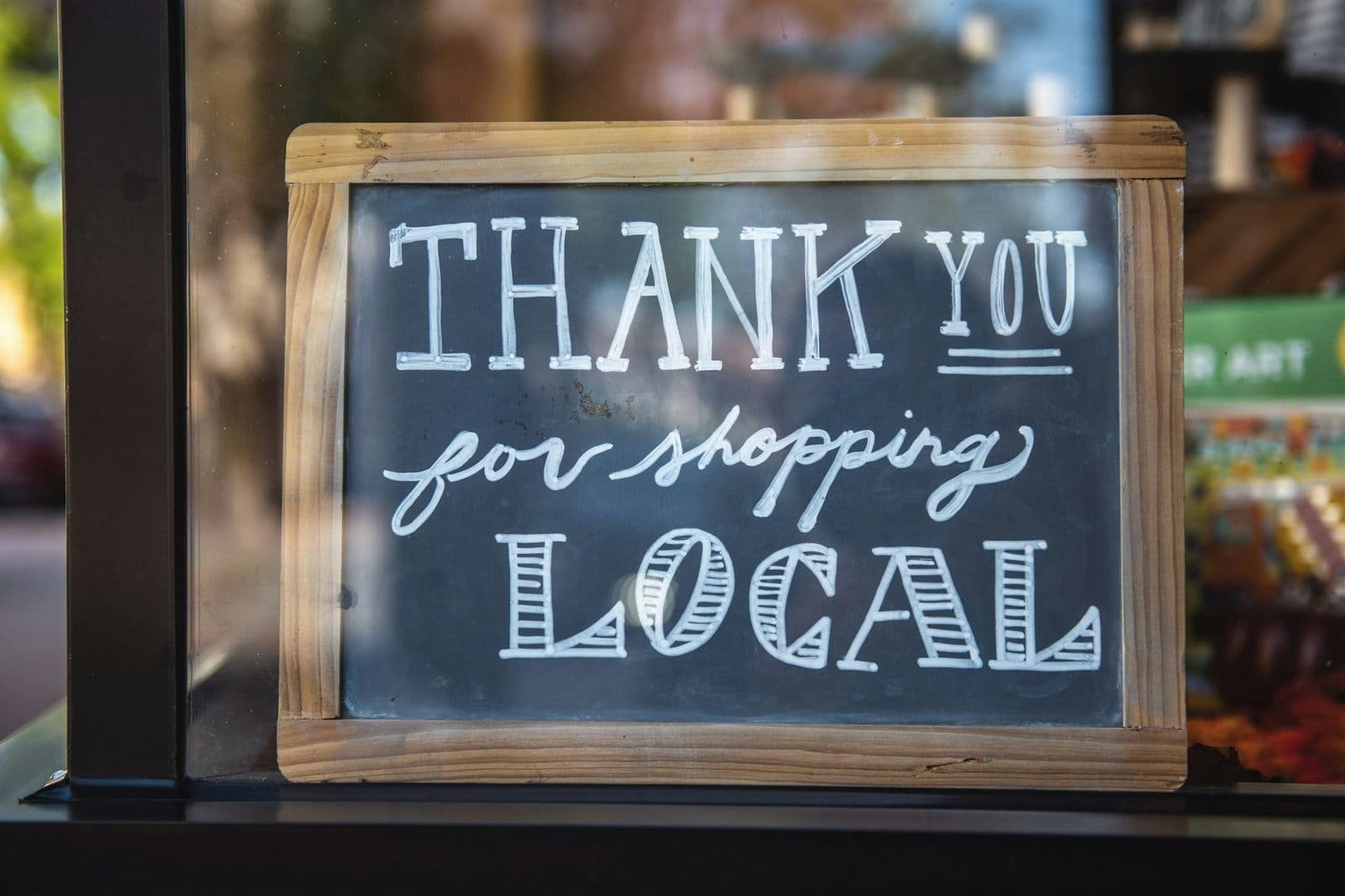 Thank you for shopping local chalkboard sign in a small business window